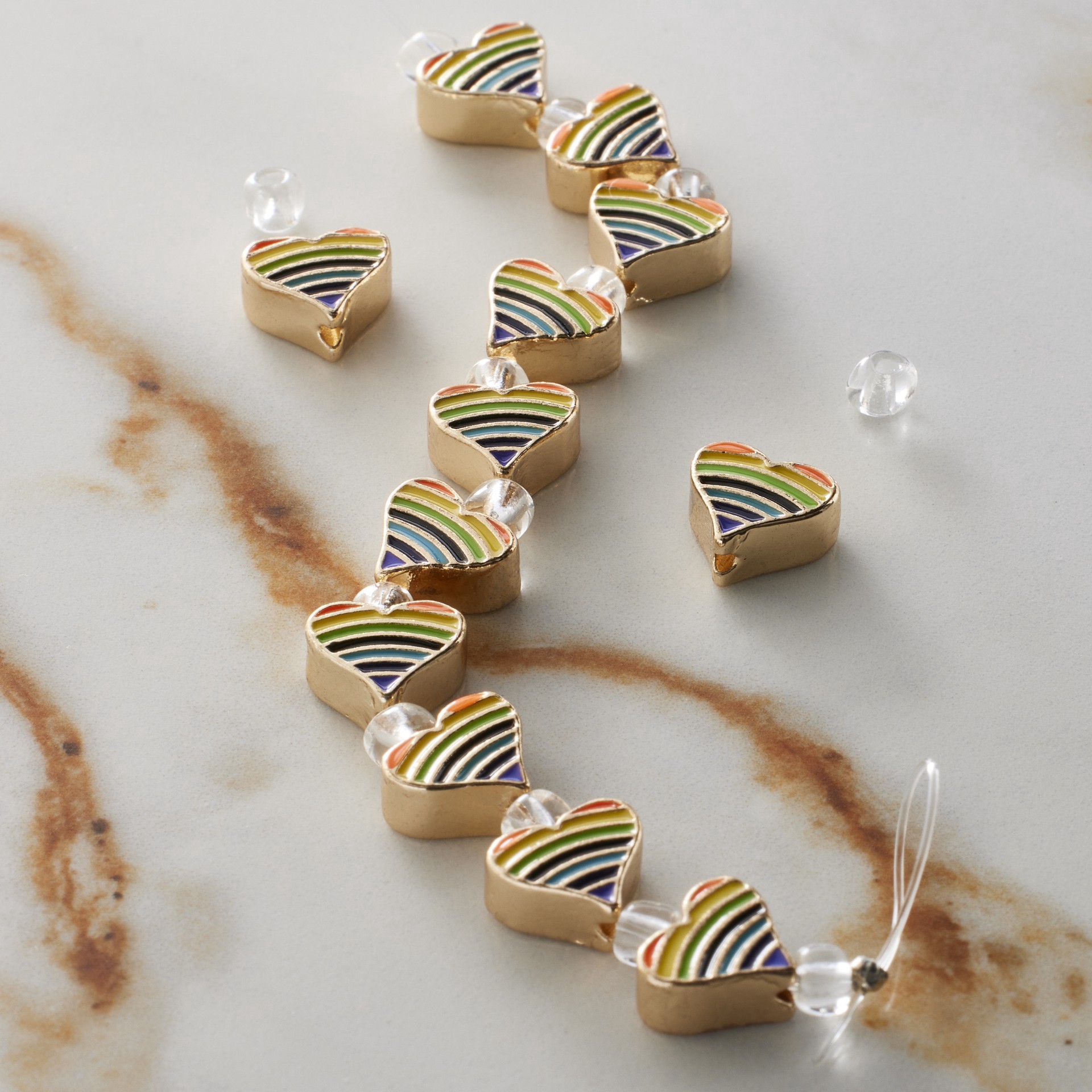 slide 2 of 3, Rainbow Stripe & Gold Heart Beads, 9mm By Bead Landing, 9 mm