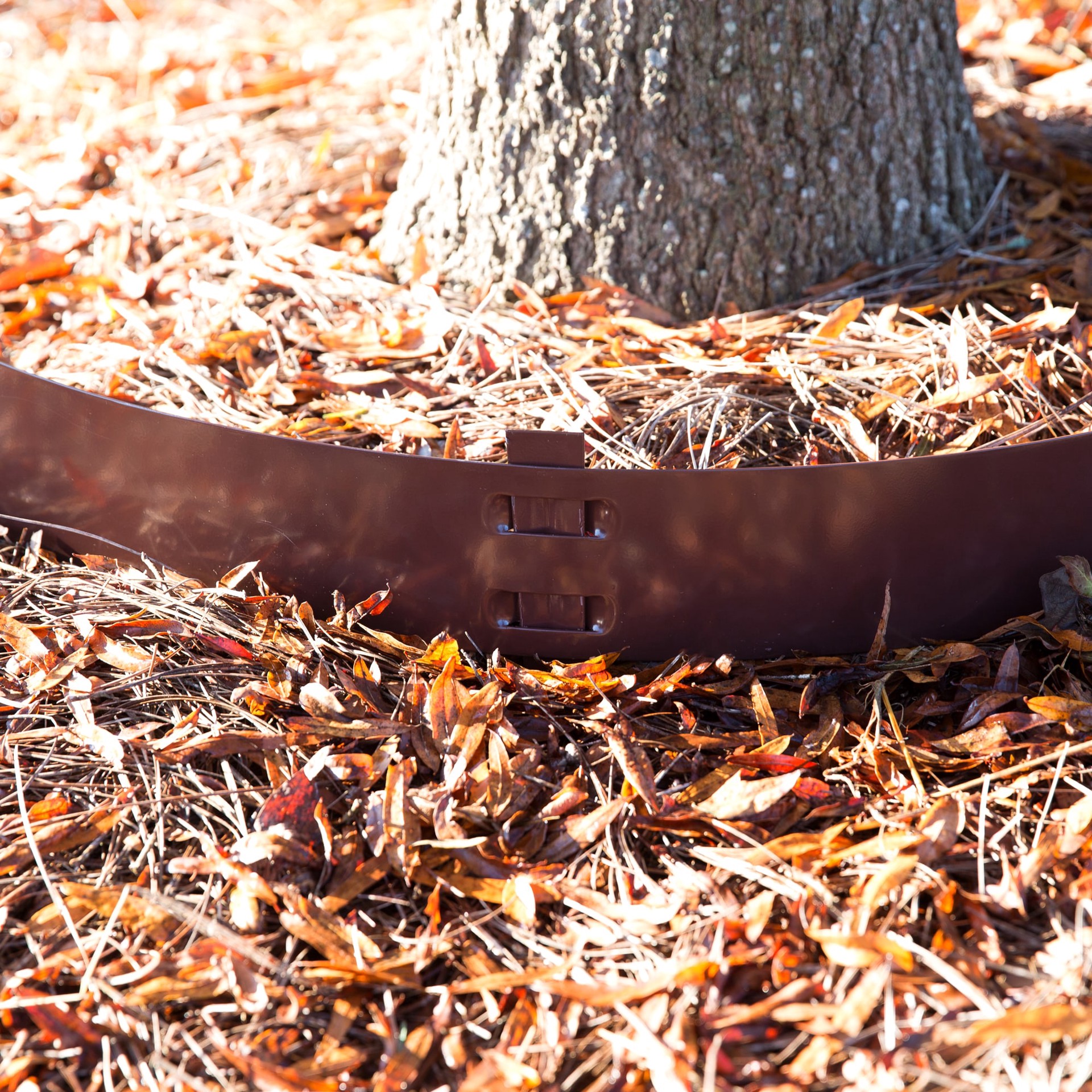 slide 2 of 3, Colmet 4 x 4-in Tree Ring Brown Steel Landscape edging section with stakes, 1 ct
