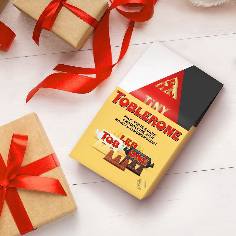 slide 14 of 15, TOBLERONE Tiny Assorted Chocolate Bars Variety Pack (Milk, Dark, & White), 1 Gift Bag (15 Pieces), 4.23 oz