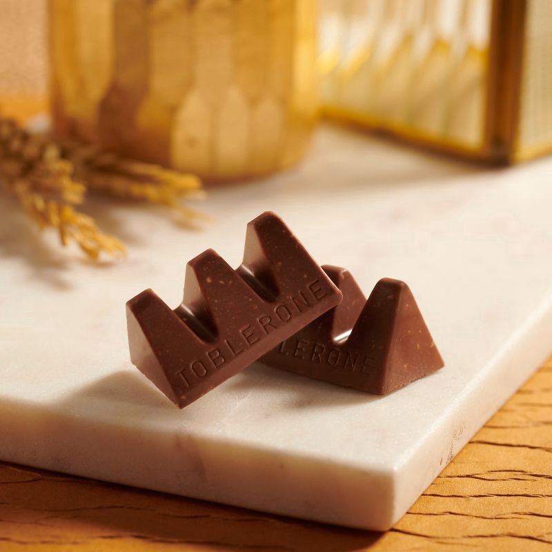 slide 5 of 14, TOBLERONE Tiny Milk Chocolate Bars with Honey and Almond Nougat, 1 Gift Bag (18 Pieces), 5.07 oz