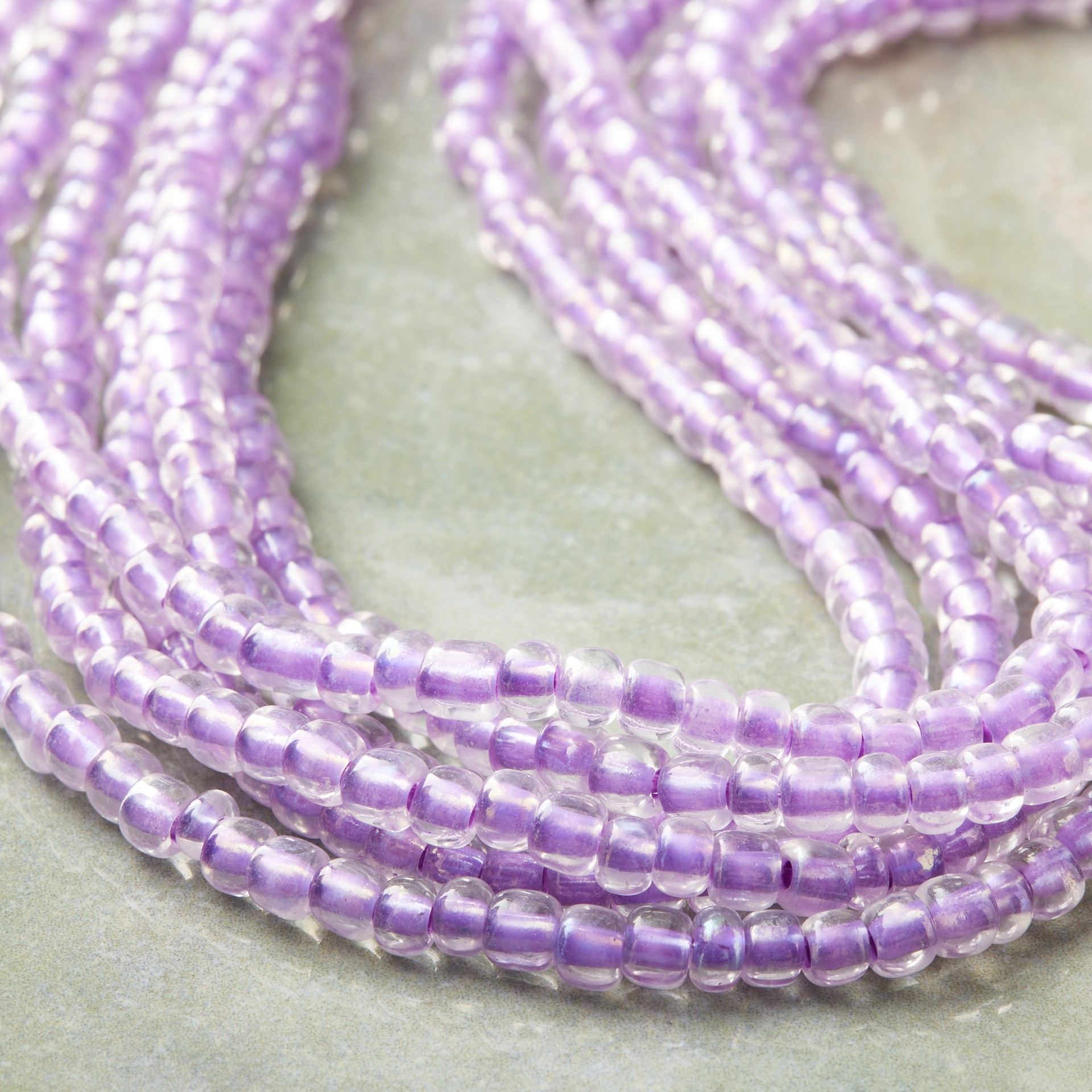 slide 2 of 3, Purple Aurora Borealis Glass Seed Beads, 6/0 By Bead Landing, 6/0