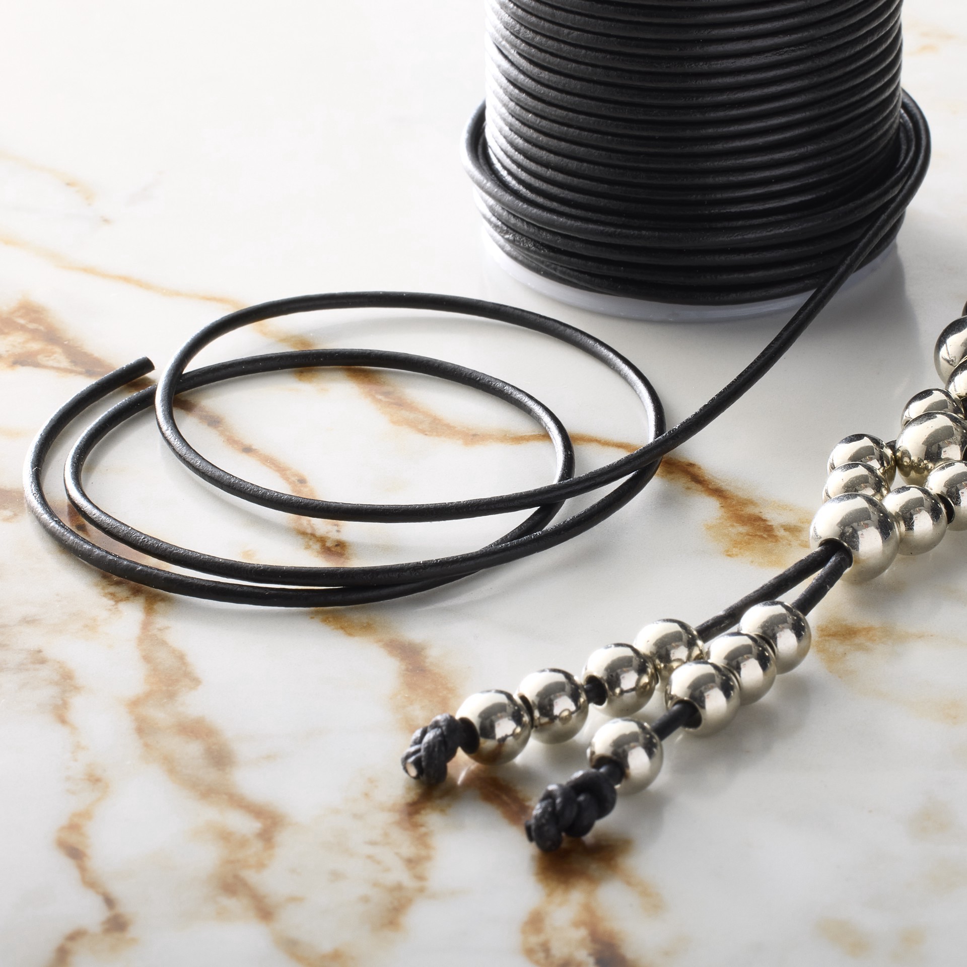 slide 2 of 3, 2mm Black Round Leather Cord By Bead Landing, 25yd., 2mm