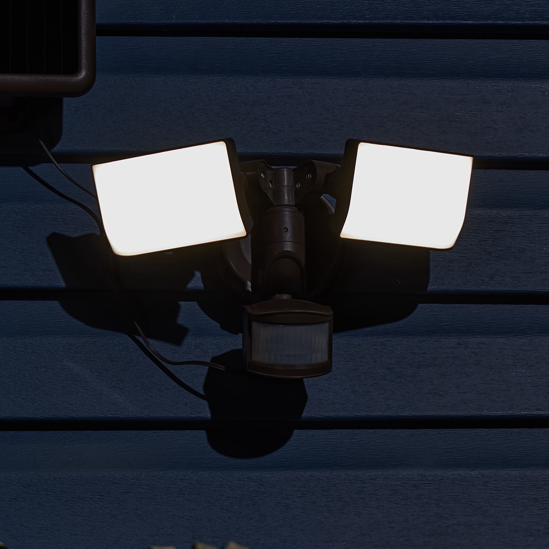 slide 6 of 6, Utilitech 180 -Degree 90 -Wattage Equivalent Solar LED Bronze 2 -Head Motion-Activated Flood Light with Timer 1200 -Lumen, 1 ct