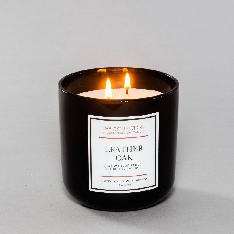 slide 2 of 3, 2-Wick Black Glass Leather Oak Lidded Jar Candle 12oz - The Collection by Chesapeake Bay Candle, 12 oz