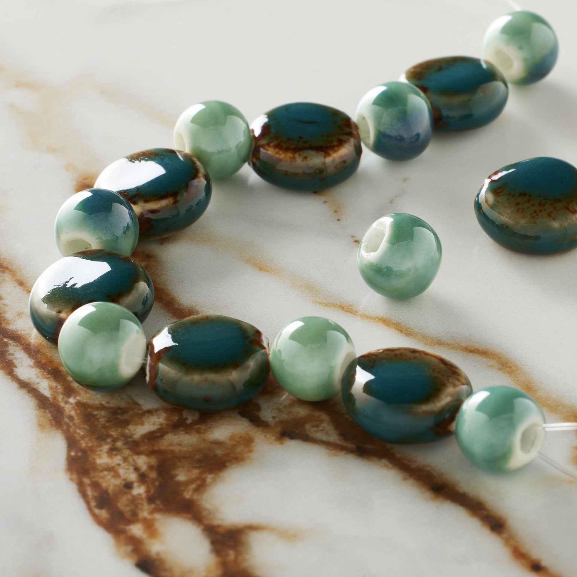 slide 3 of 3, Teal Reactive Glaze Ceramic Disc & Round Beads By Bead Landing, 10mm to 15mm