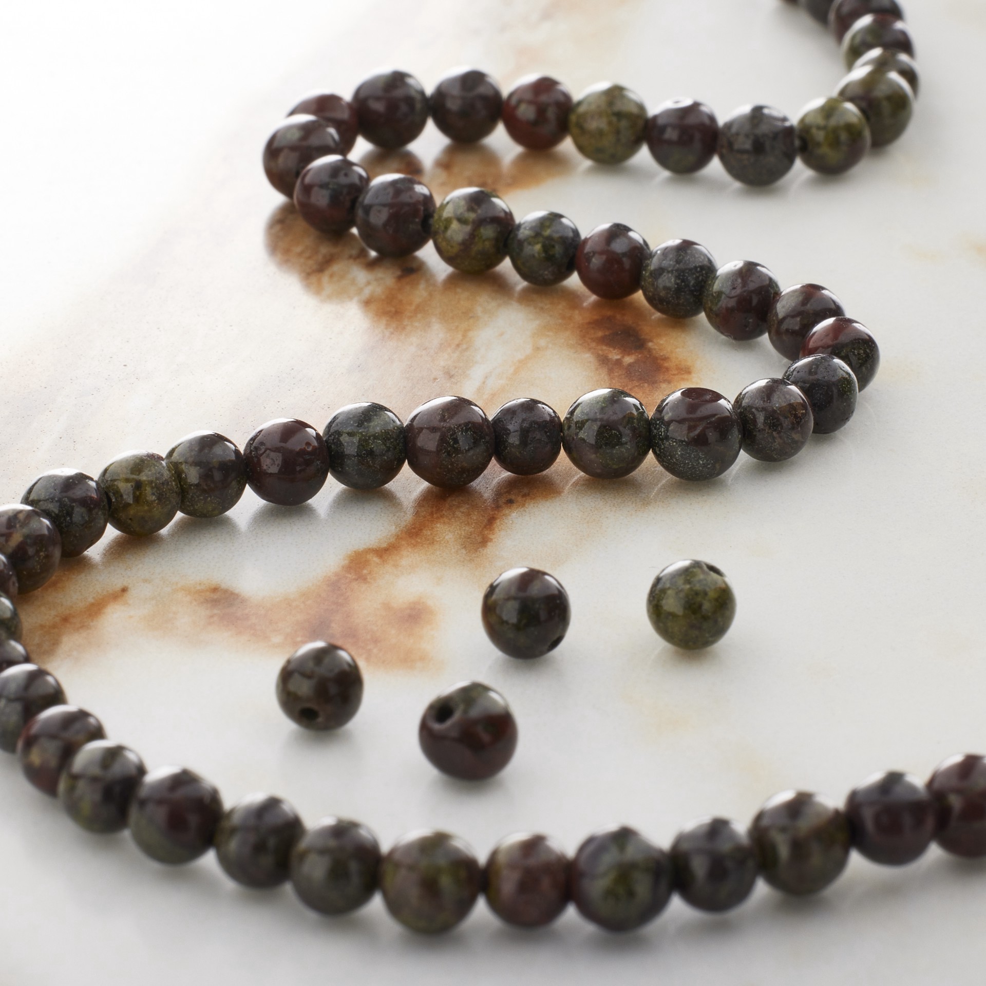 slide 2 of 3, Dark Green & Red Dragon Blood Round Beads By Bead Landing, 4 mm