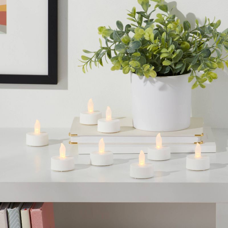 slide 2 of 3, 50ct Twist-Flame LED Tealight Candles (White) - Room Essentials™: Battery-Operated, Plastic Housing, Includes CR2032, 50 ct