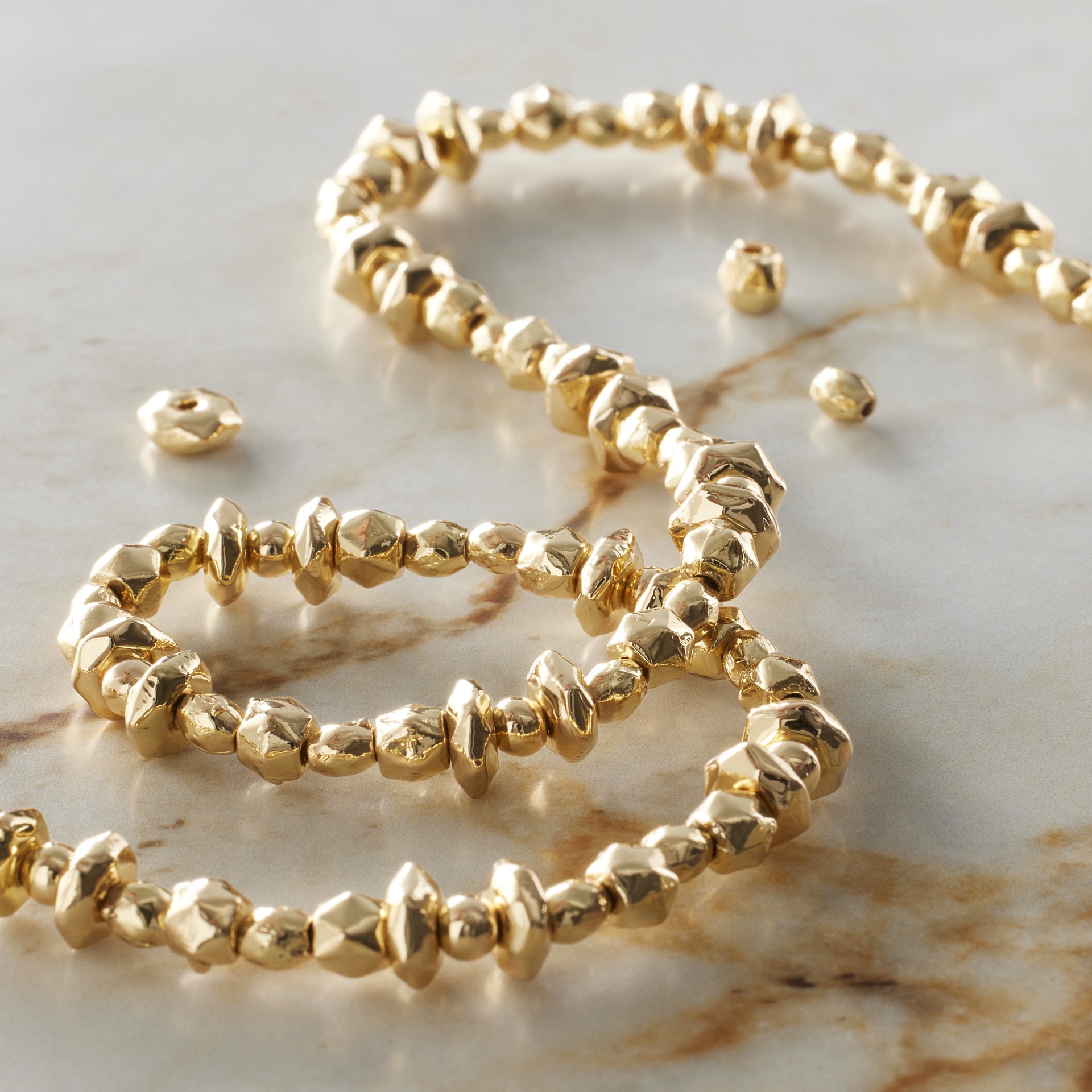 slide 2 of 3, Gold Faceted Metal Bead Mix By Bead Landing, 4mm x 3mm