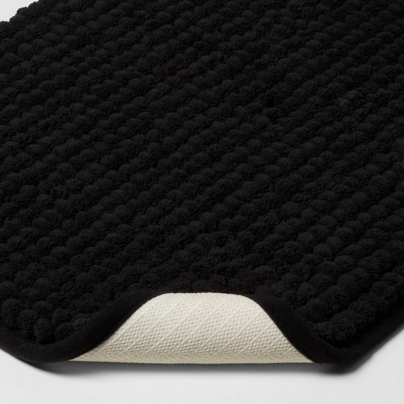 slide 3 of 6, 17"x24" Chunky Chenille Cushion Foam Bath Rug Black - Room Essentials™, 1 ct