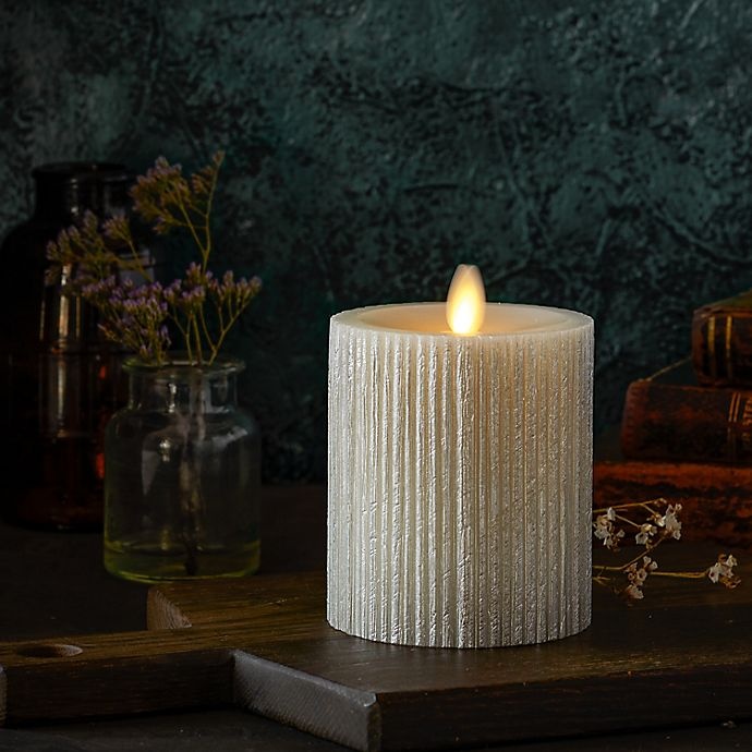 slide 3 of 3, Luminara Moving Flame Champagne Ribbed Real-Flame Effect Pillar Candle, 4.5 in