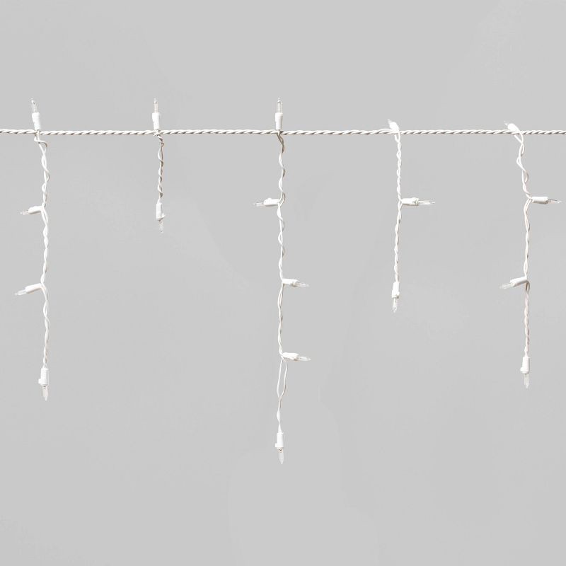 slide 3 of 5, 70ct LED Christmas Icicle Lights Cool White with White Wire - Wondershop™, 70 ct