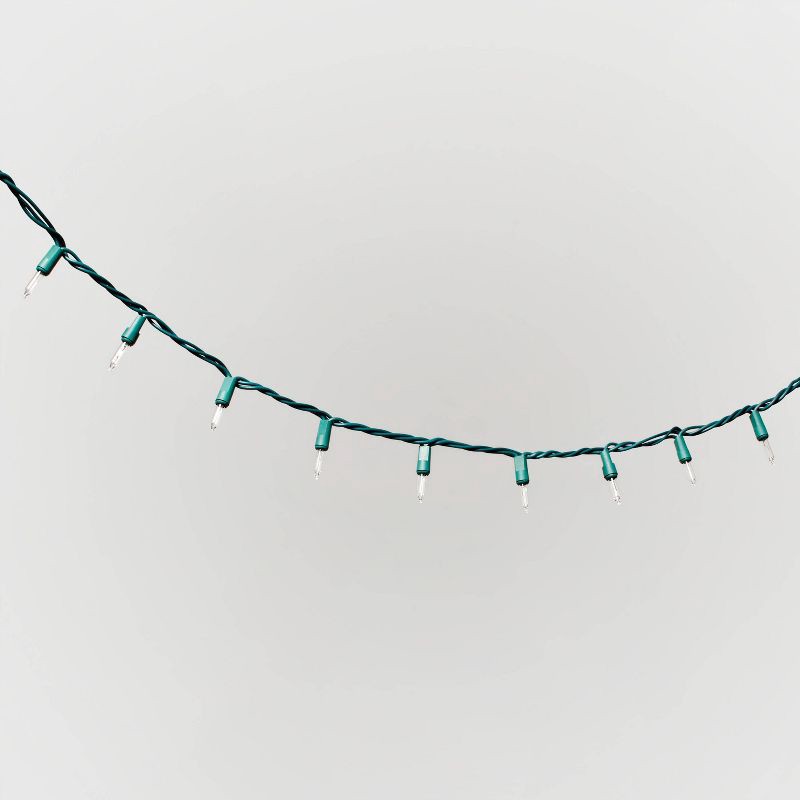 slide 3 of 5, 100ct Incandescent Smooth Mini Christmas String Lights Clear Twinkle with Green Wire - Wondershop™, 100 ct