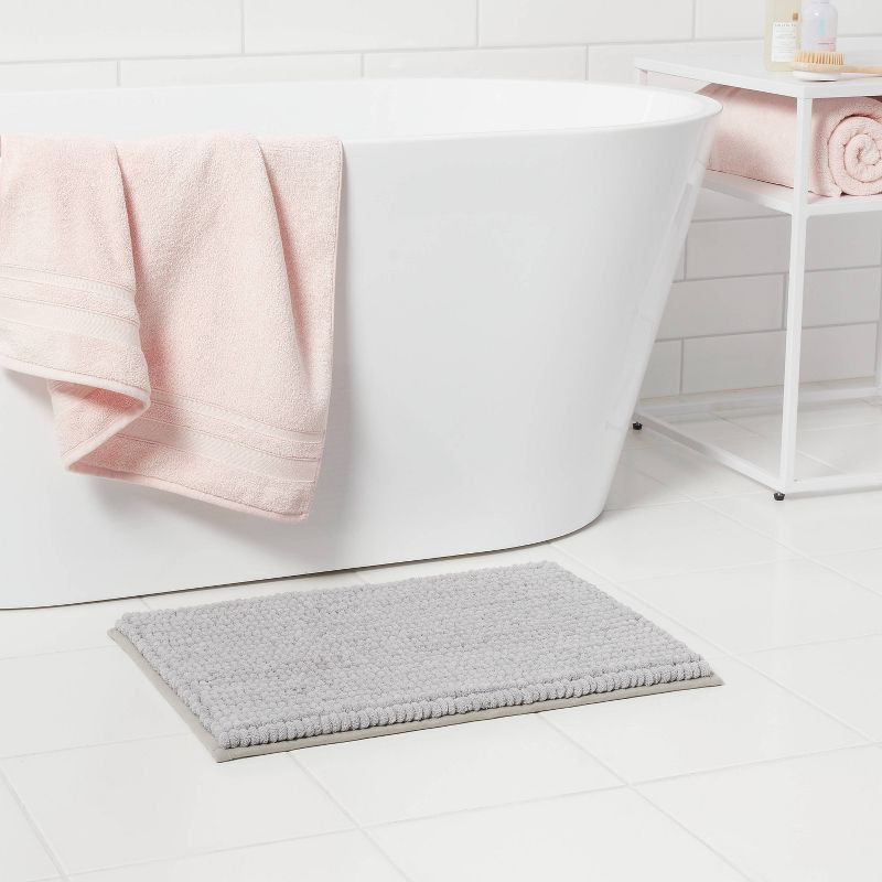 slide 2 of 4, 17"x24" Chunky Chenille Cushion Foam Bath Rug Light Gray - Room Essentials™, 1 ct