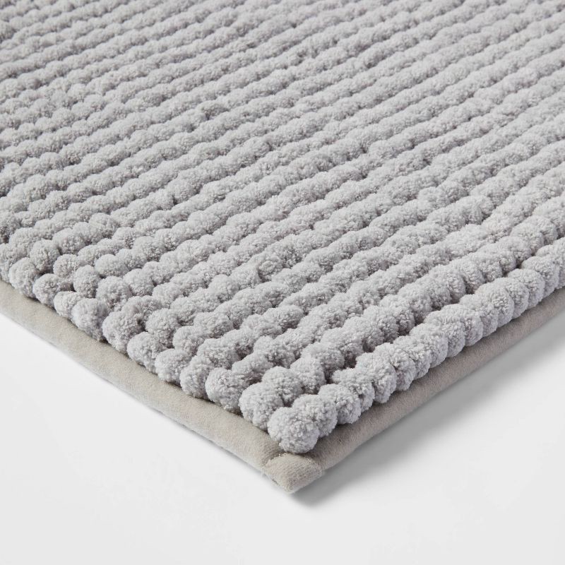 slide 3 of 4, 17"x24" Chunky Chenille Cushion Foam Bath Rug Light Gray - Room Essentials™, 1 ct