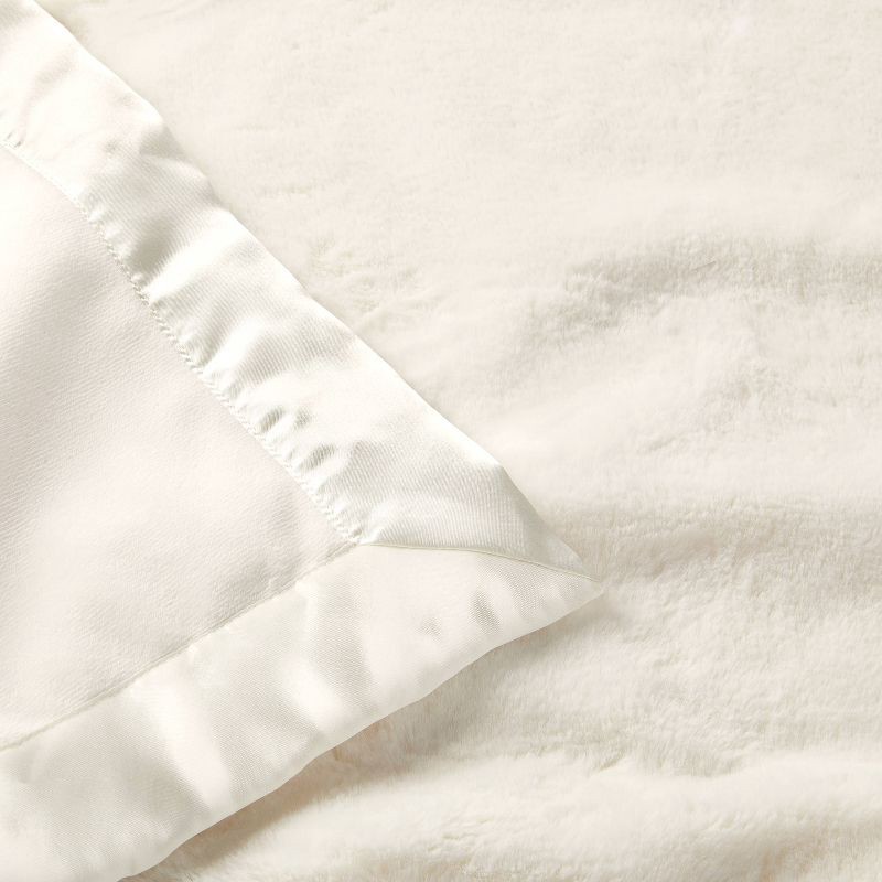 slide 3 of 4, Solid Satin Edge Plush Baby Blanket - Cream - Cloud Island™, 1 ct