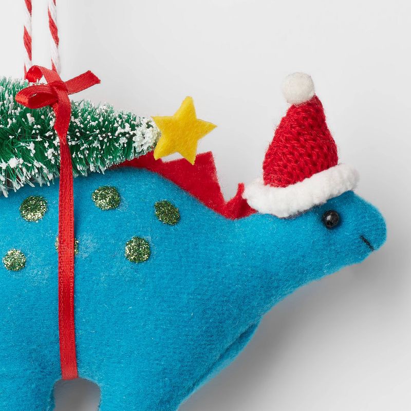 slide 3 of 3, Fabric Stegosaurus with Tree Christmas Tree Ornament Blue - Wondershop™, 1 ct