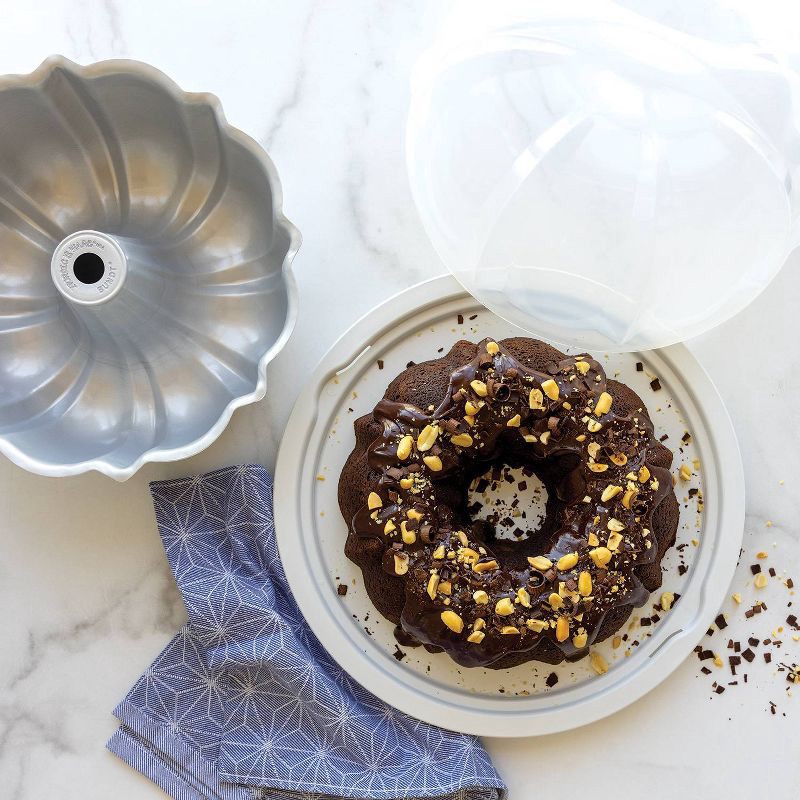 slide 6 of 7, Nordic Ware 12 Cup Formed Aluminum Bundt Pan Blue with Cake Keeper: Nonstick Baking Pan, Dishwasher-Safe, 10-Year Warranty, 1 ct