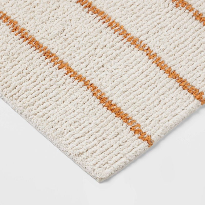slide 3 of 4, 20"x30" Modern Tufted Stripe Bath Rug Yellow/Cream - Threshold™, 1 ct