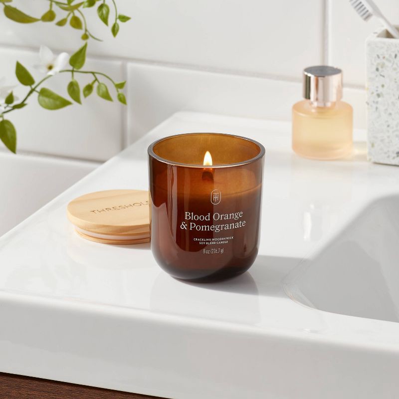 slide 2 of 3, Amber Glass Wooden Wick Orange and Pomegranate Jar Candle 8oz - Threshold™, 8 oz