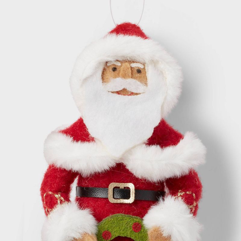 slide 3 of 3, Fabric Santa Holding Wreath Christmas Tree Ornament - Wondershop™, 1 ct
