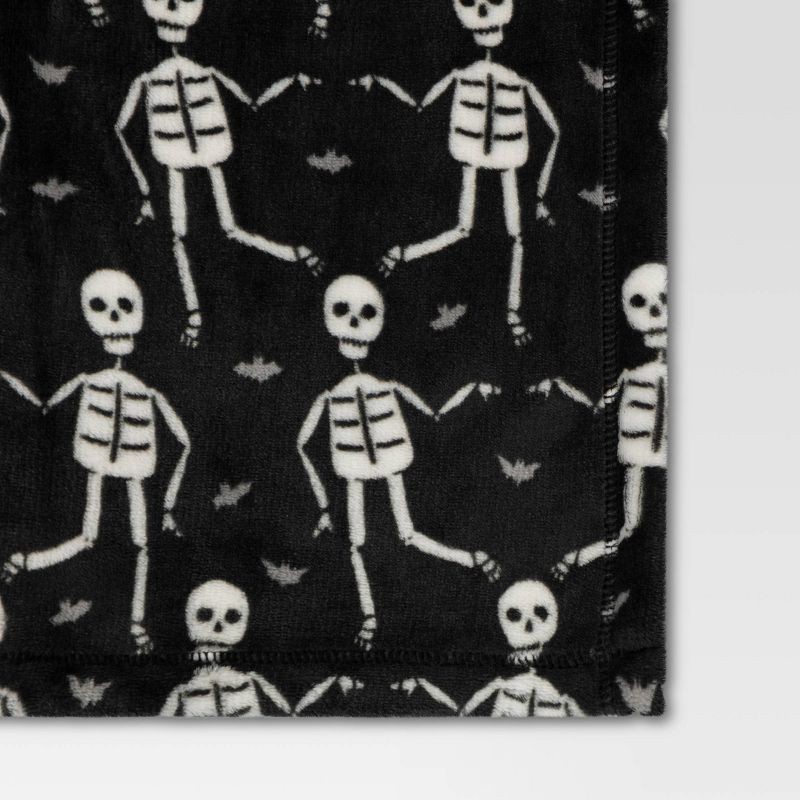 slide 4 of 4, Halloween Printed Skeleton Throw Blanket Black/Ivory - Hyde & EEK! Boutique™: Recycled Polyester, Knitted, 50x60", Machine Washable, 1 ct