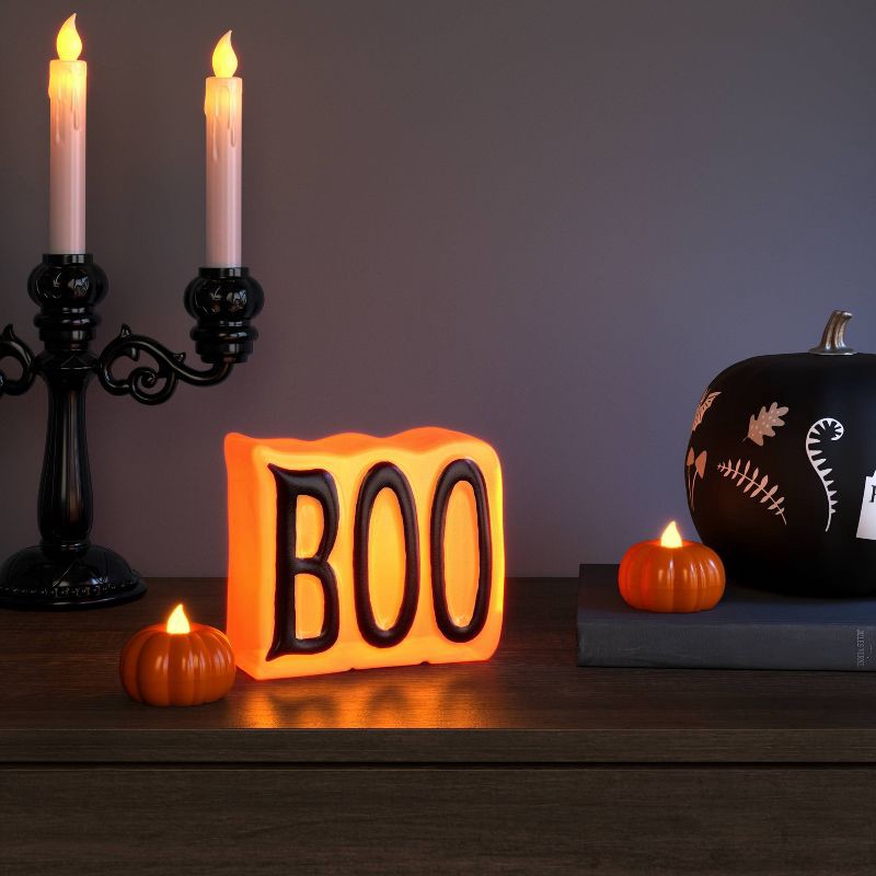 slide 2 of 3, 2pk LED Pumpkin Shaped Halloween Tea Lights with Warm Orange Flickering Flame - Hyde and EEK! Boutique™, 2 ct