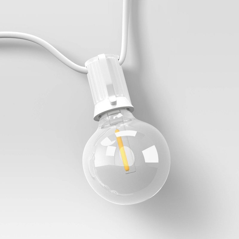 slide 4 of 4, 20ct LED Indoor Outdoor Globe String Lights Clear Bulbs with White Wire - Room Essentials™, 20 ct