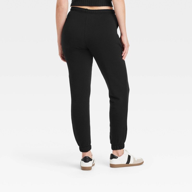 slide 2 of 3, Women's Leisure Studio Mid-Rise Fleece Essential Joggers - Universal Thread™ Black S: Cotton Fleece, Relaxed Leg, 1 ct