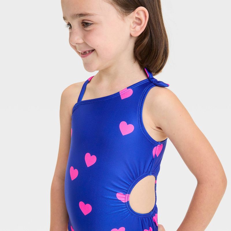 slide 3 of 3, Baby Girls' Heart Printed Cut Out One Piece Swimsuit With Bow - Cat & Jack™ Blue 18M: Asymmetrical Back, UPF 50+, Elastic Leg Openings, 1 ct
