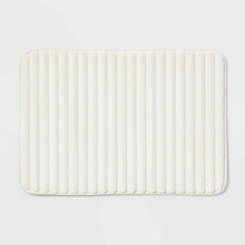slide 1 of 4, 17"x24" Ribbed Cushion Foam Bath Rug Cream - Room Essentials™, 1 ct