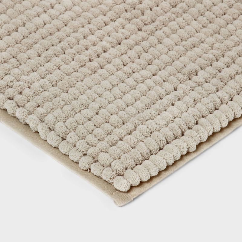 slide 3 of 4, 17"x24" Chunky Chenille Cushion Foam Bath Rug Tan - Room Essentials™, 1 ct
