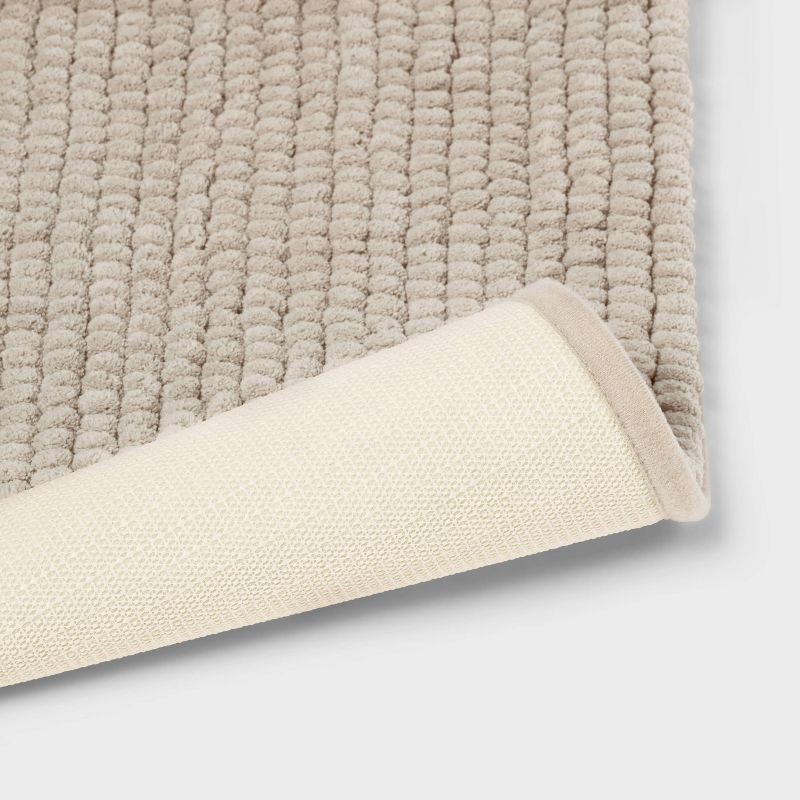 slide 4 of 4, 17"x24" Chunky Chenille Cushion Foam Bath Rug Tan - Room Essentials™, 1 ct