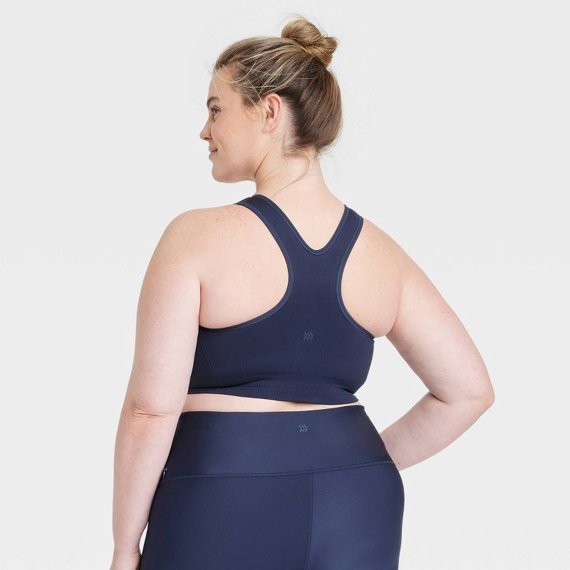slide 2 of 6, Women's Seamless Medium Support Racerback Sports Bra - All In Motion™ Navy Blue XS: Moisture Wicking, Removable Padding, Pullover Design, 1 ct