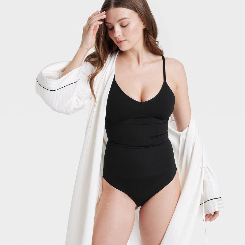 slide 3 of 6, Women's Medium Shaping Seamless Thong Bodysuit - Auden™ Black M: Medium Compression, Tummy Slimming, Adjustable Strap, 1 ct