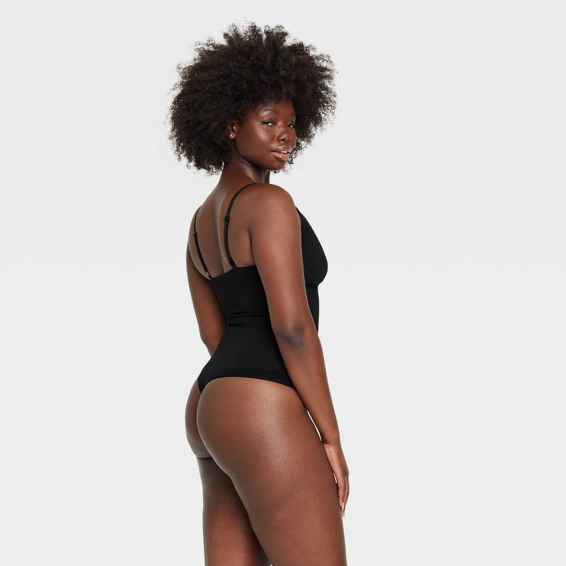 slide 5 of 6, Women's Medium Shaping Seamless Thong Bodysuit - Auden™ Black M: Medium Compression, Tummy Slimming, Adjustable Strap, 1 ct