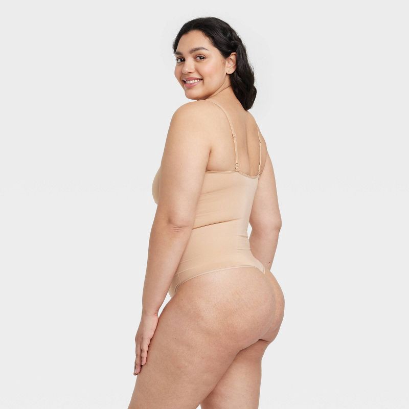 slide 5 of 6, Women's Medium Shaping Seamless Thong Bodysuit - Auden™ Pearl Tan XS: Nylon Spandex, Adjustable Strap, 1 ct