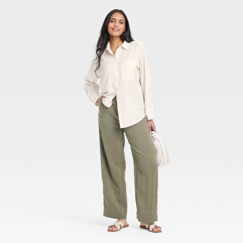 slide 3 of 3, Women's Oversized Long Sleeve Crinkle Button-Down Shirt - A New Day™ Cream S: Rayon-Nylon Blend, Poplin Fabric, 1 ct