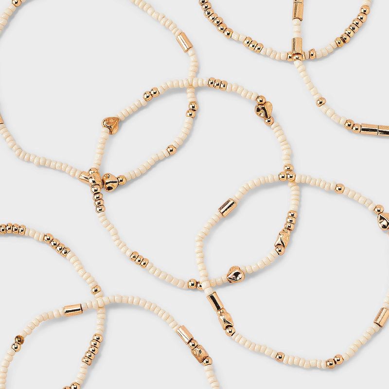 slide 4 of 4, Heart Beaded Bracelet Set 7pc - Universal Thread™ Ivory: Pull-On Stretch Bracelets, Glass & Acrylic, Heart Shape, 2.2" Length, 7 ct