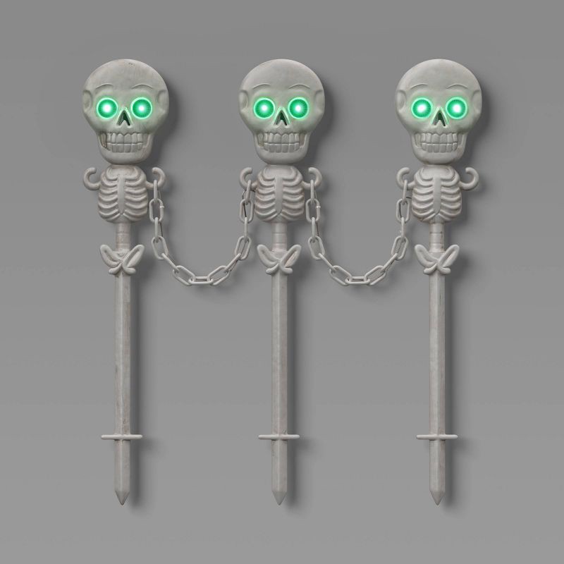 slide 1 of 3, 49" Skeletons Fence Stakes Halloween Decorative Prop Off-White - Hyde and EEK! Boutique™, 49 in