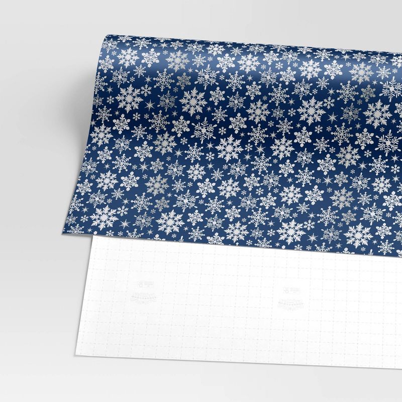 slide 3 of 3, 30" 25 sq ft Christmas Roll Wrap White Snowflakes on Blue - Wondershop™, 25 sq ft