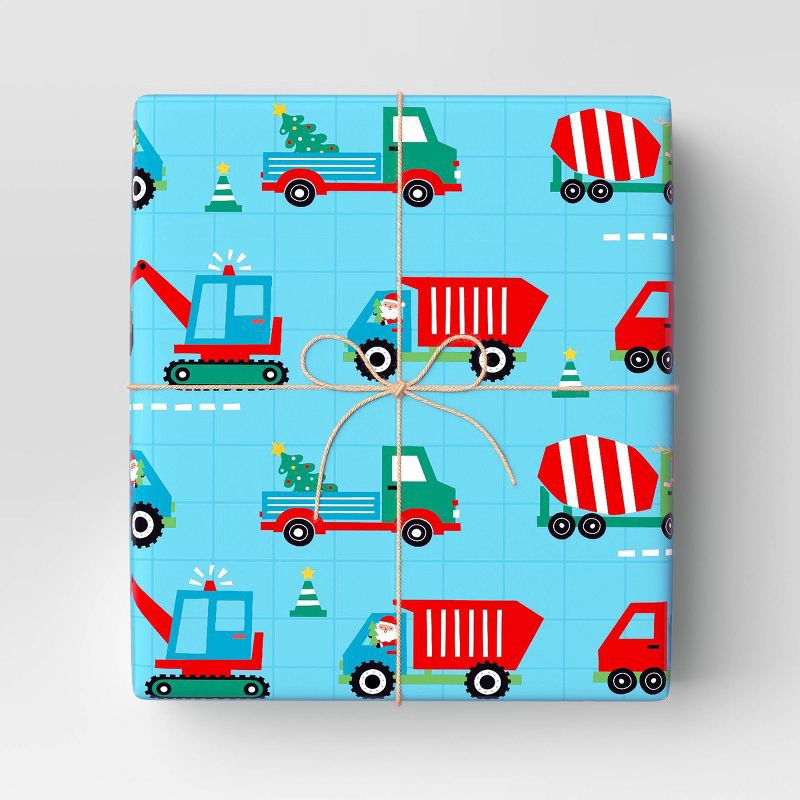 slide 2 of 3, 30" 50 sq ft Christmas Roll Wrap Trucks on Blue - Wondershop™, 50 sq ft