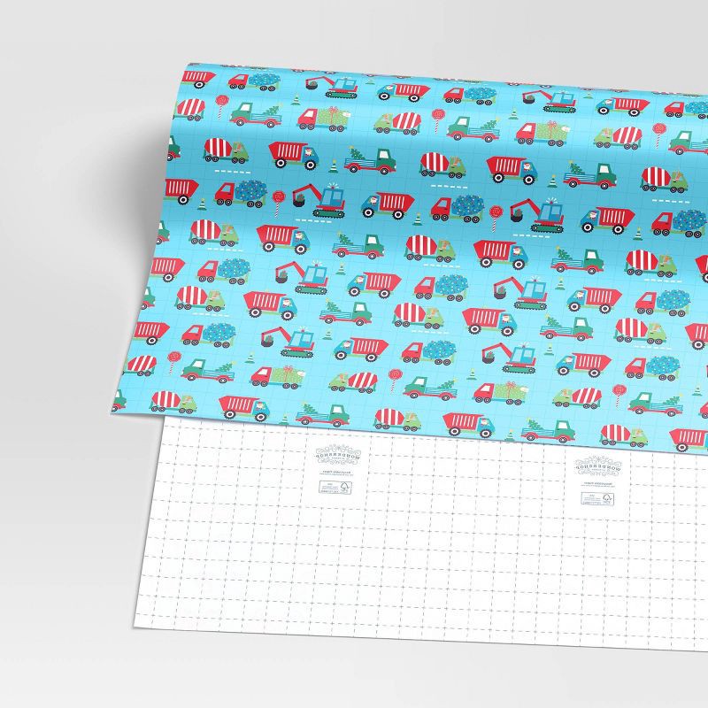 slide 3 of 3, 30" 50 sq ft Christmas Roll Wrap Trucks on Blue - Wondershop™, 50 sq ft