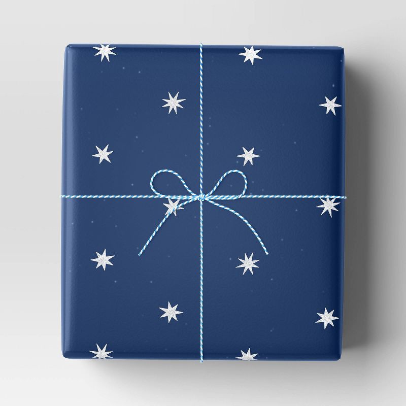 slide 2 of 3, 30" 25 sq ft Christmas Roll Wrap White Stars on Blue - Wondershop™, 25 sq ft