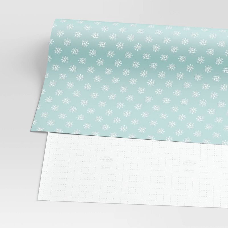 slide 3 of 3, 30" 20 sq ft Christmas Roll Wrap White Snowflakes on Light Blue - Wondershop™, 20 sq ft