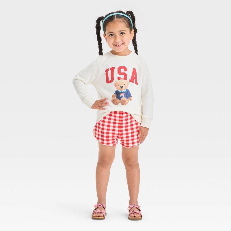 slide 1 of 4, Grayson Mini Toddler Girls' 2pc Americana USA Teddy Bear Pullover Sweatshirt and Gingham Shorts Set - Red 12M, 2 ct