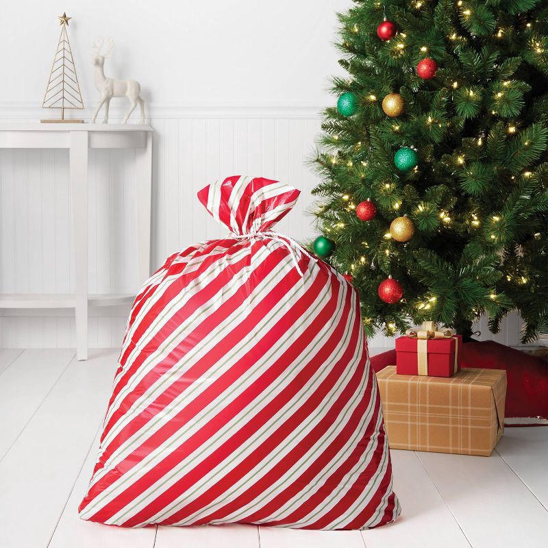 slide 2 of 3, 30"x 36" Red and Green Stripes Christmas Gift Sack - Wondershop™, 1 ct