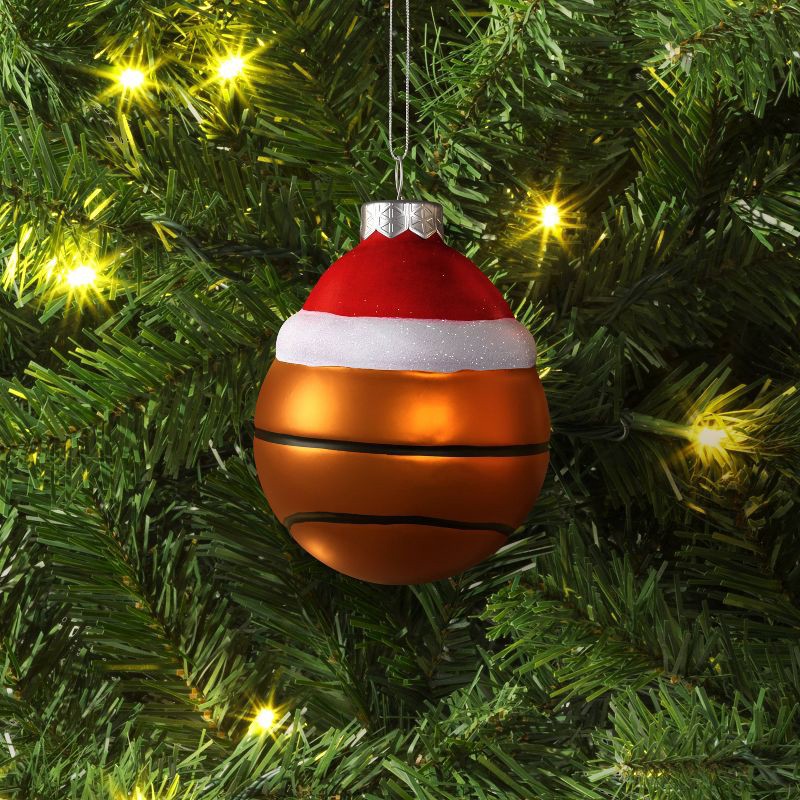 slide 2 of 3, 4" Christmas Glass Santa Hat Basketball Ornament - Wondershop™, 1 ct