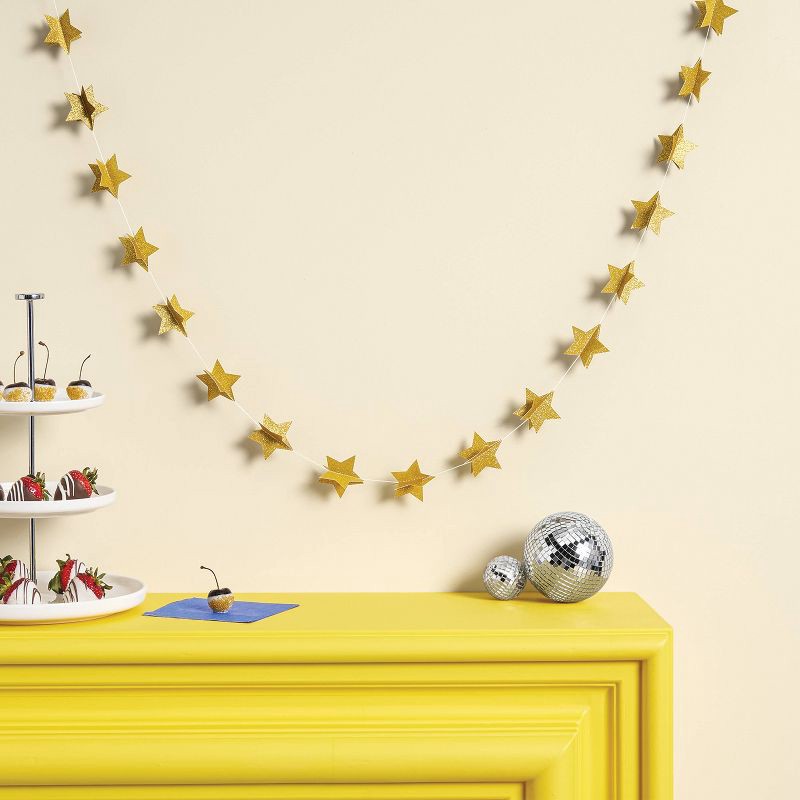 slide 2 of 4, New Year's Eve Gold Stars Paper Garland - Spritz™, 1 ct