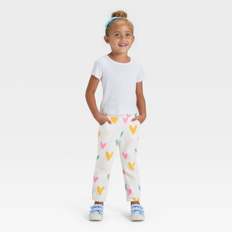 slide 3 of 3, Toddler Girls' Hearts Fleece Jogger Pants - Cat & Jack™ Cream 18M, 1 ct