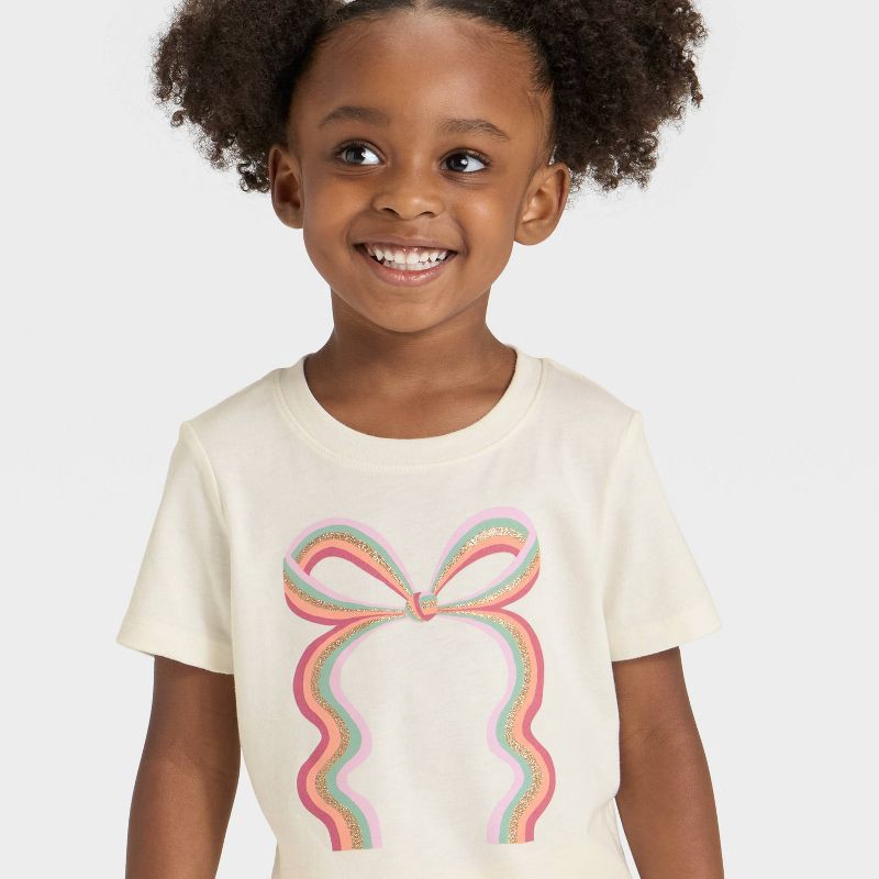 slide 2 of 4, Toddler Girls' Short Sleeve Rainbow Bow Graphic T-Shirt - Cat & Jack™ Cream 12M, 1 ct